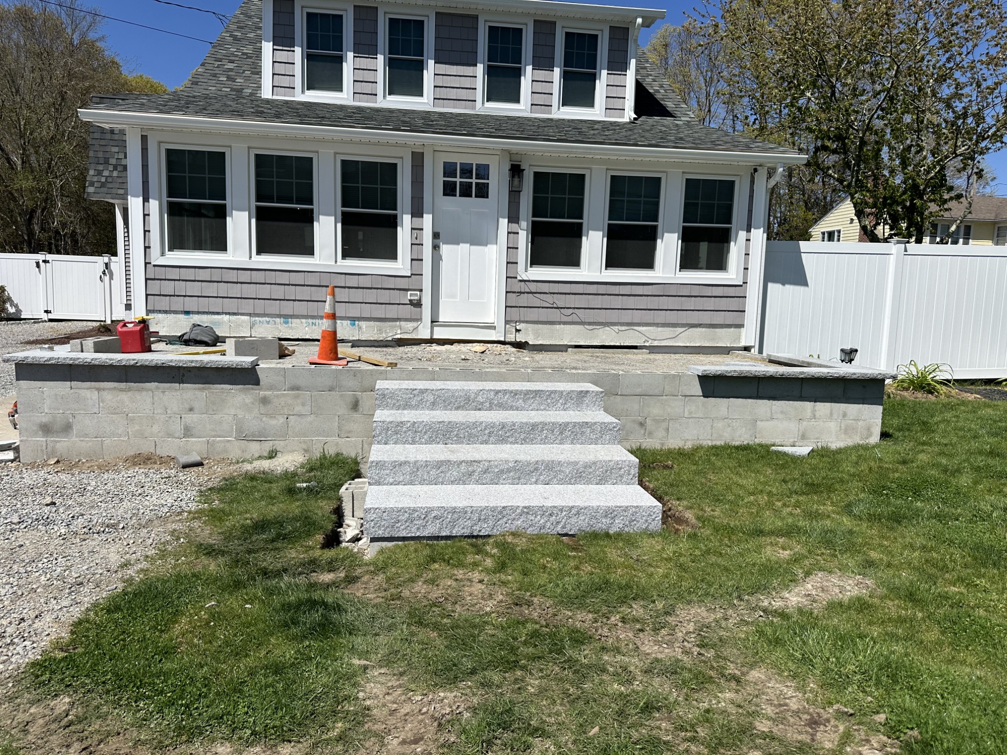Finished stone retaining wall and granite entry steps